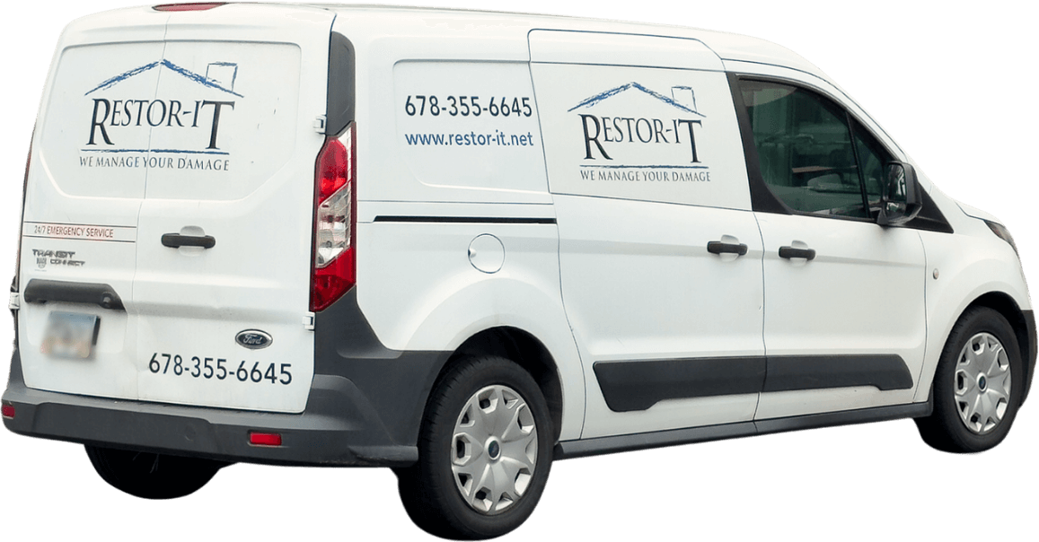 Flooring Installation 3 White van with "Restor-It" logo and contact information, including phone number and website URL, on the side and rear. The slogan reads, "We Manage Your Damage." Our services are designed to restore your property efficiently and effectively.