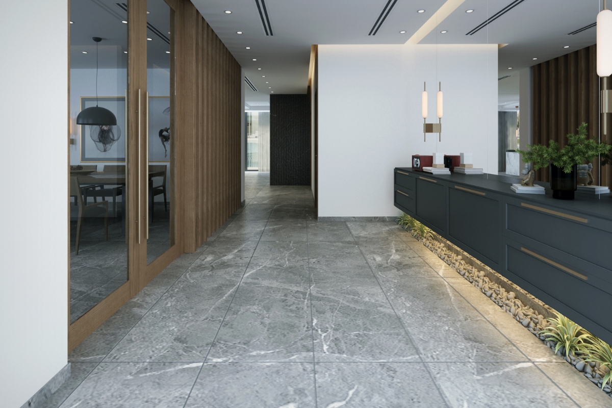 Tile Flooring Installation: Why It’s A Great Choice For Atlanta Homes 13 Modern office reception area featuring expert tile flooring installation with gray tiles, a dark reception desk, pendant lights, indoor plants, and a glass-walled meeting room on the left.
