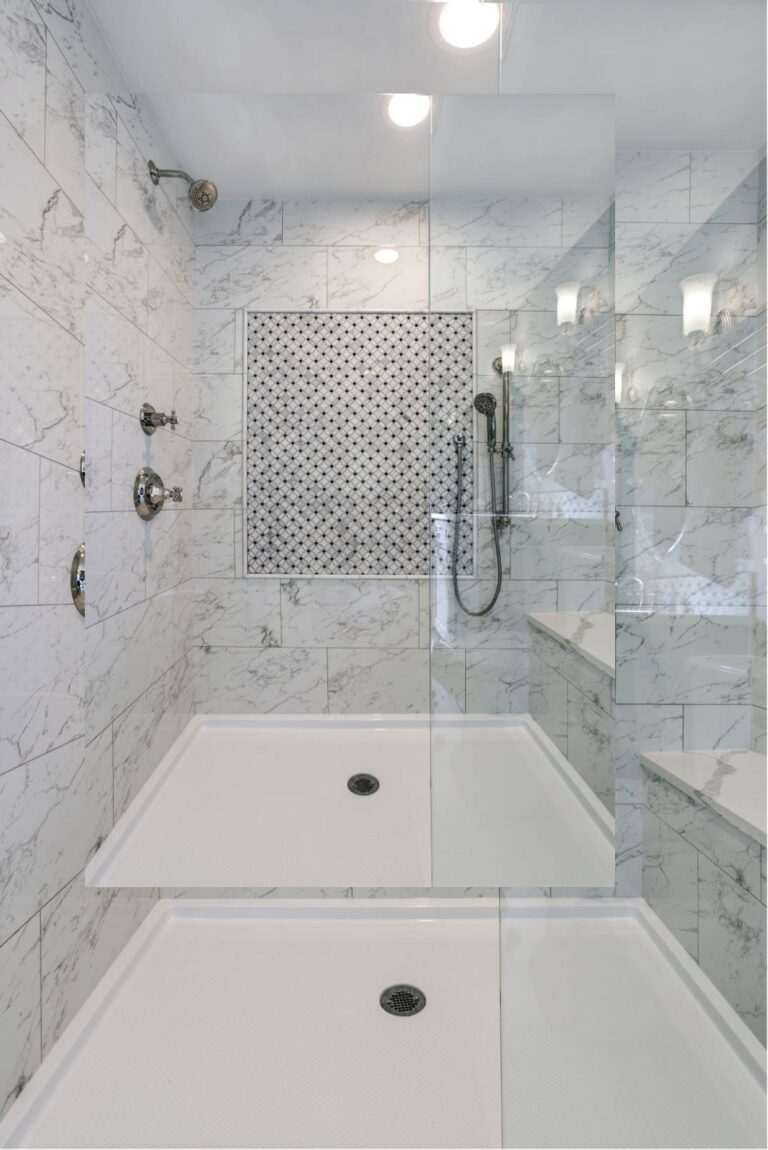 Bathroom And Shower Remodeling 9 Modern double shower featuring white marble tile walls, a glass divider, two showerheads, and a patterned tile accent panel—perfect for any bathroom remodeling or shower remodeling project.
